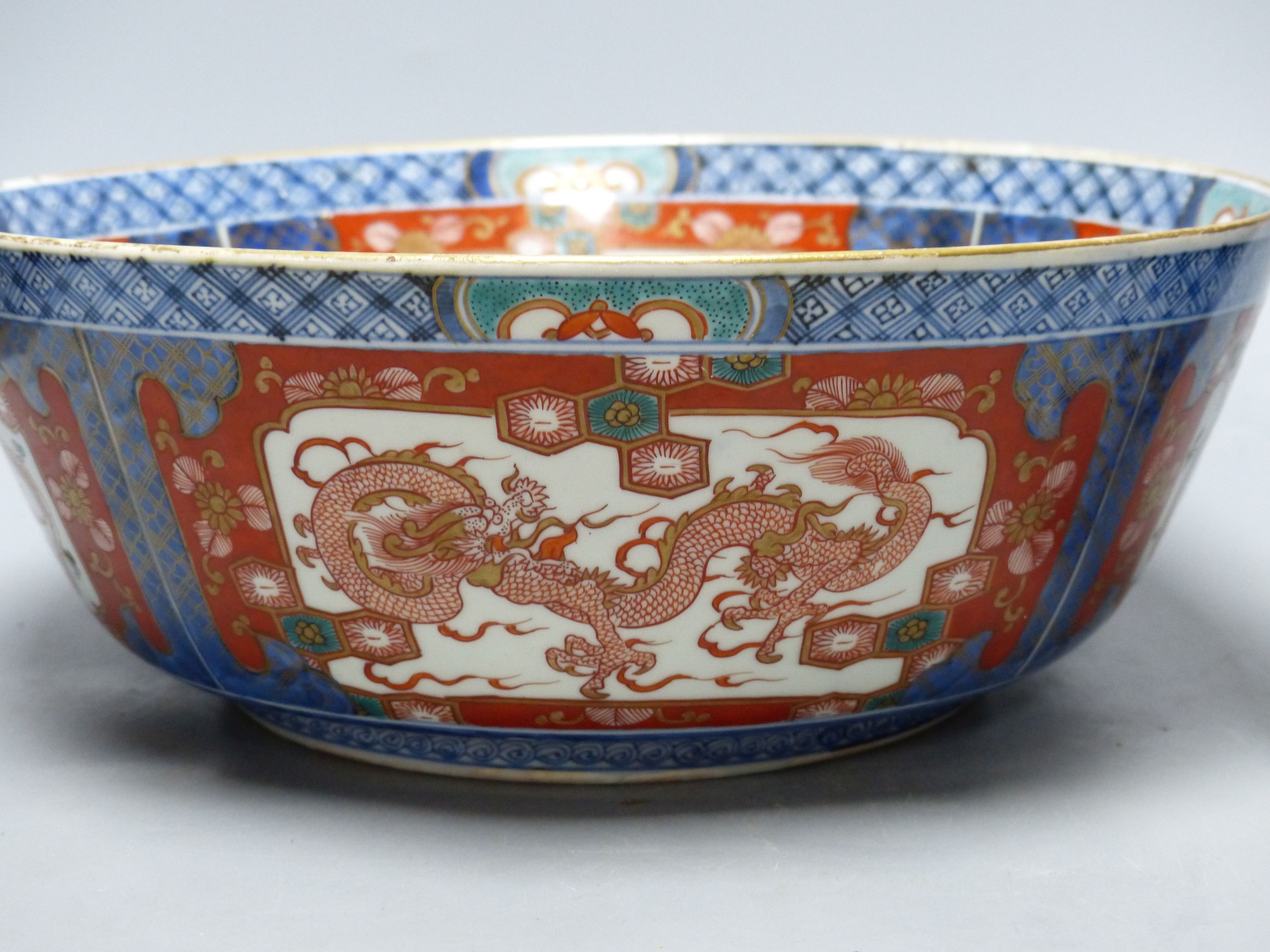 A large Japanese Imari bowl, Meiji period, diameter 31cm, and a Chinese blue and white sleeve vase